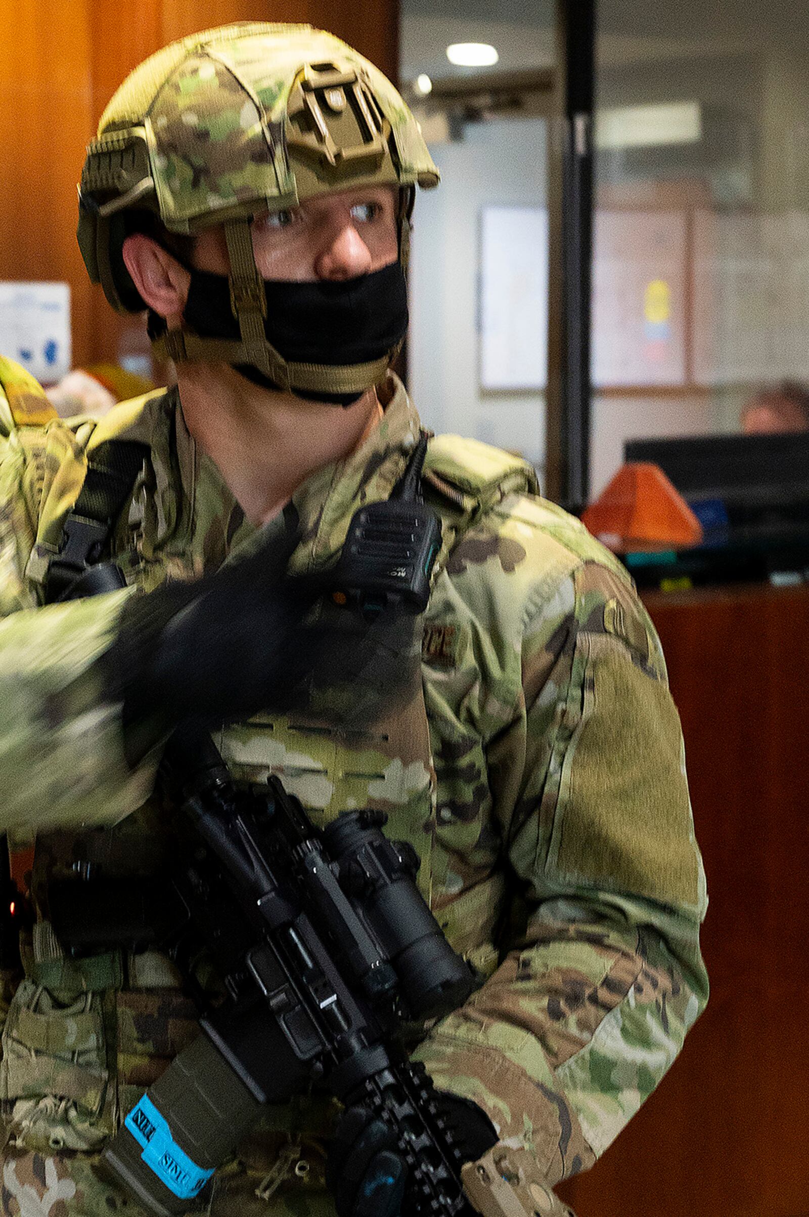 A Defender with the 88th Security Forces Squadron reaches for his radio during an active-shooter exercise Feb. 23 at Wright-Patterson Air Force Base. The exercise gave first responders, including police, fire and medical personnel, the opportunity to practice coordinating emergency actions and procedures. U.S. AIR FORCE PHOTO/R.J. ORIEZ