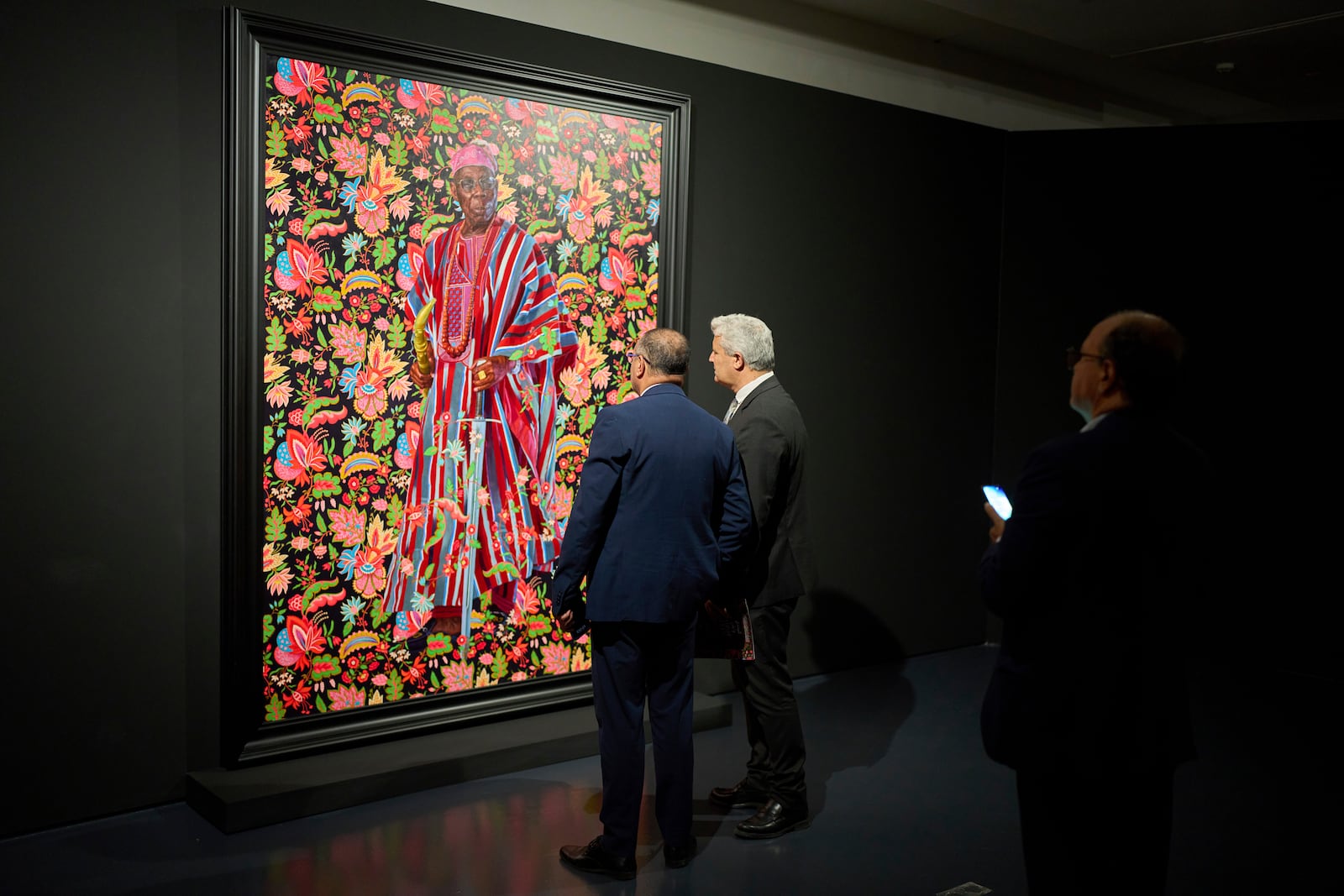 Visitors look at a portrait of Oluṣẹgun Ọbasanjọ, former President of Nigeria, during the opening of American painter Kehinde Wiley's exhibition A Maze of Power in Mohammed VI Museum of Modern and Contemporary Art, in Rabat, Tuesday, April 15, 2025. (AP Photo/Mosa'ab Elshamy)