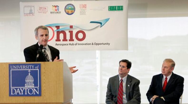 Dan Foley, the Montgomery County Commissioner, with Daniel Curran (center), the Univeristy of Dayton President, and Ohio Governor Ted Strickland in the background, speaks during a an update on the Ohio Hub of Innovation & Opportunity program.