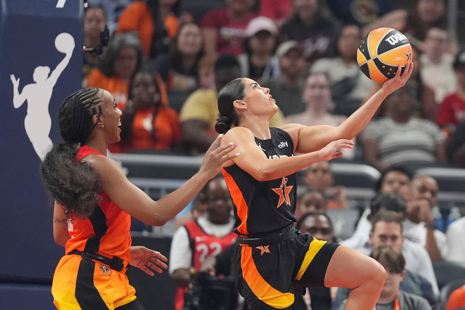 Los Angeles Sparks's Kelsey Plum, right, puts up a shot against Golden State Valkyries' Kayla Thornton during the first half of a WNBA All-Star basketball game, Saturday, July 19, 2025, in Indianapolis. (AP Photo/Michael Conroy)