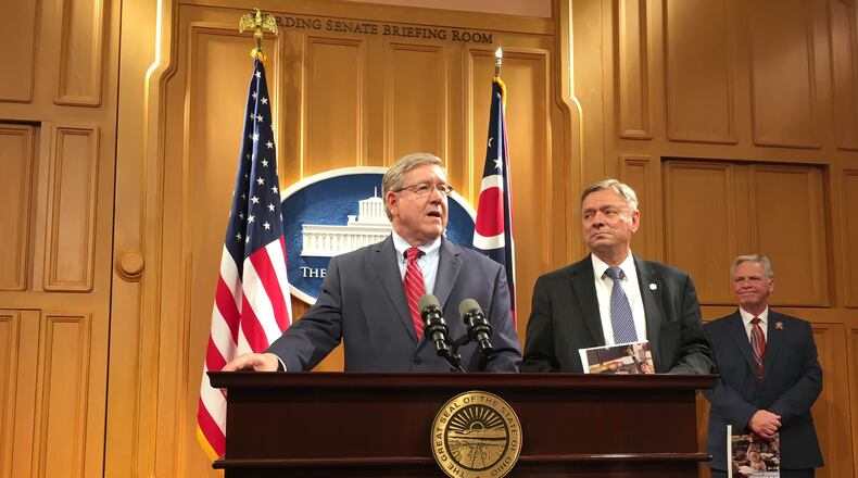 State Representatives Bob Cupp (left) and John Patterson describe a new school funding proposal Monday, March 25, at the Ohio Statehouse. LAURA A. BISCHOFF / STAFF
