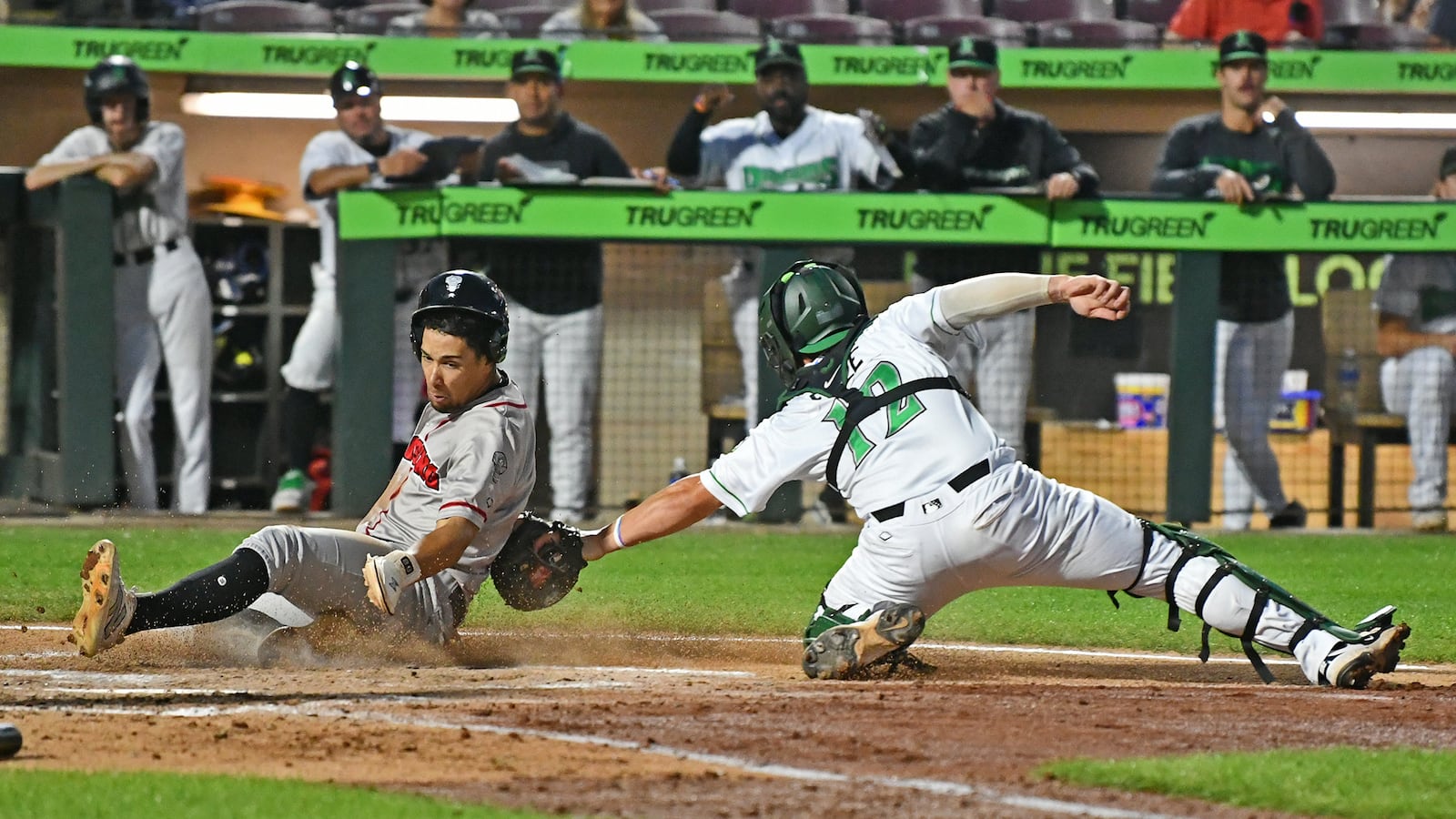 Dragons catcher John Michael Faile applies the tag in time on a throw from left fielder Anthony Stephan, but the ball got away and the run scored. JEFF GILBERT/CONTRIBUTED