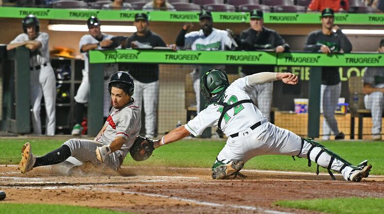 Dragons catcher John Michael Faile applies the tag in time on a throw from left fielder Anthony Stephan, but the ball got away and the run scored during their game against Lansing on Wednesday, Sept. 3 at Day Air Ball Park. JEFF GILBERT/CONTRIBUTED