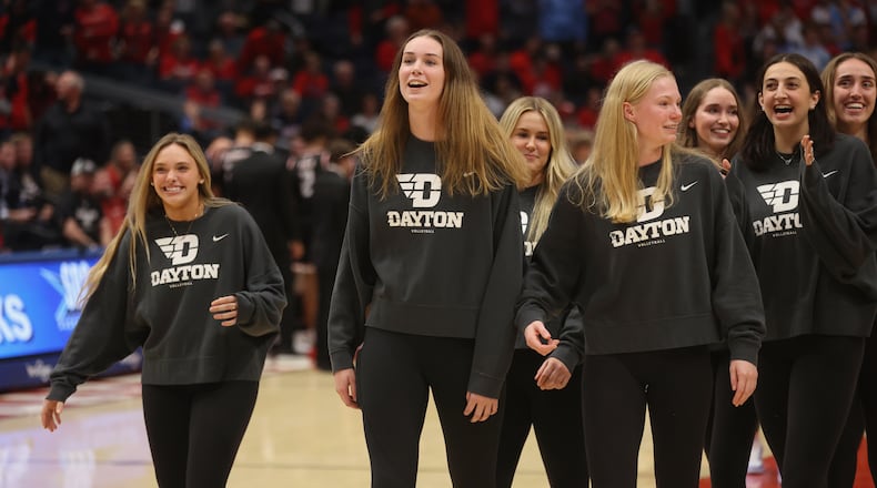 Dayton volleyball players leave the court after being honored on Monday, Nov. 6, 2023, during a men's basketball game at UD Arena. David Jablonski/Staff