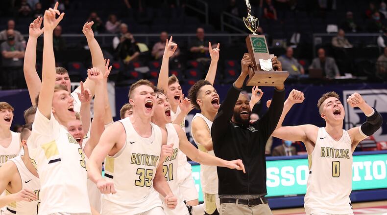 The Botkins High School boys basketball team celebrates a 60-44 win over Columbus Grove 60-44 in the Division IV state championship game at UD Arena on Sunday, March 21, 2021. It's the first boys basketball state title in school history. Michael Cooper/CONTRIBUTED