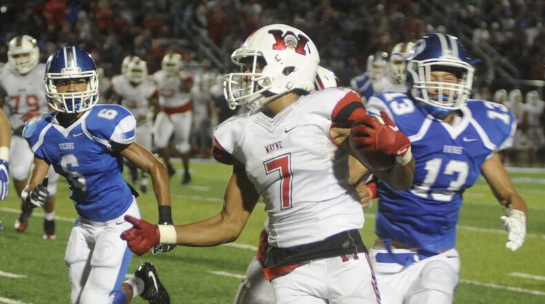 Wayne’s Trew Davis (with ball) gets a step on Miamisburg defenders Aralius Walters (6) and tyler Johnson (13). Miamisburg hosted Wayne in a Week 4 high school football game in what also was the debut of Holland Field on Friday, Sept. 16, 2016. MARC PENDLETON / STAFF