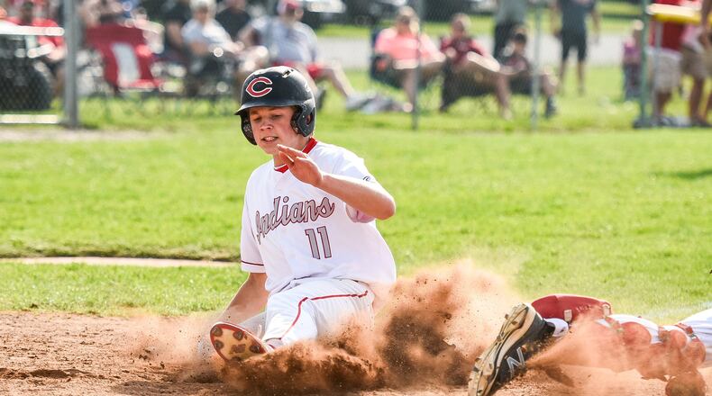 Carlisle’s Nolan Burney slides safely into home plate before the tag by Preble Shawnee catcher J.J. Hatmaker during Wednesday’s Division III sectional game at Sam Franks Field in Carlisle. NICK GRAHAM/STAFF