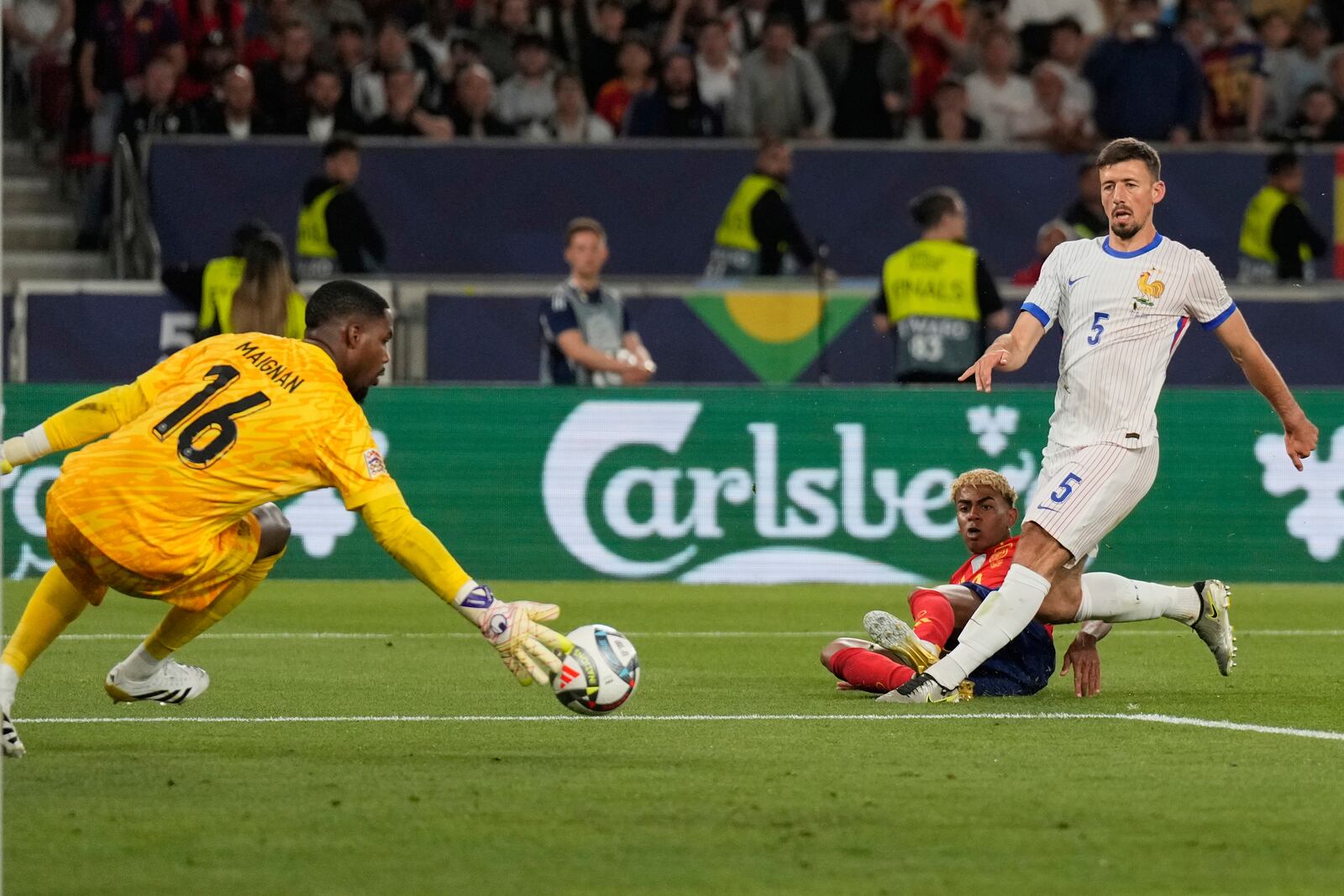 Spain's Lamine Yamal scores by France's Clement Lenglet during the Nations League semifinal soccer match between Spain and France in Stuttgart, Germany, Thursday, June 5, 2025. (AP Photo/Matthias Schrader)