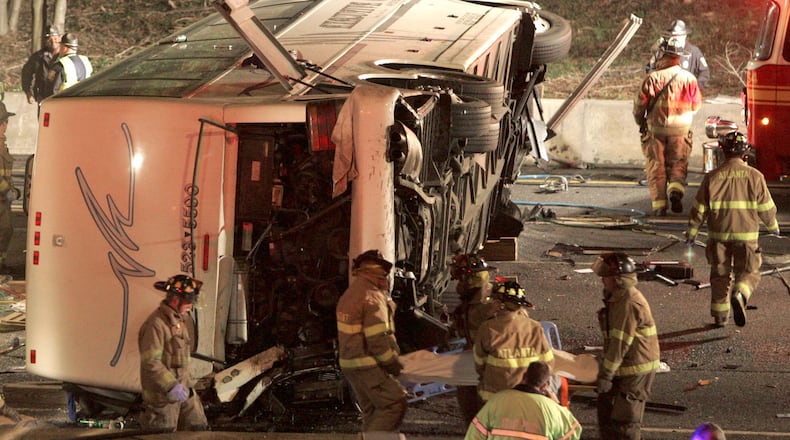 ATLANTA/ FULTON COUNTY, GA -- A coach bus carrying the Bluffton University baseball team is seen on its side after crashing and falling off an exit ramp on to Interstate 75. (JOHN SPINK/AJC staff)