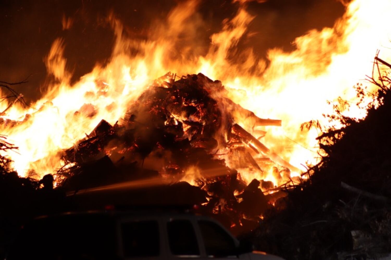 Fire crews battling huge fire in wood piles on Harshman Road