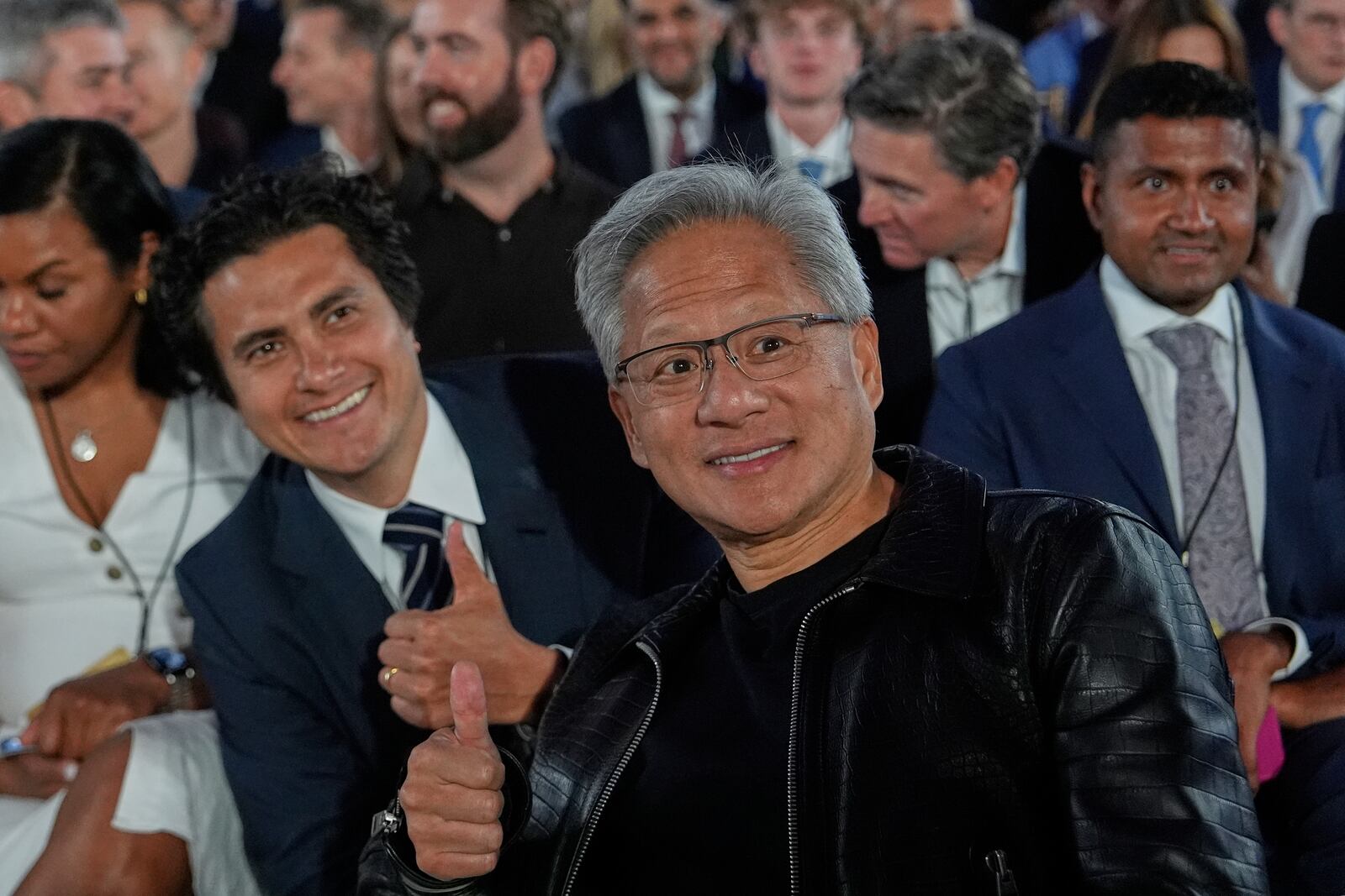 Nvidia CEO Jensen Huang poses for a photo before President Donald Trump speaks during an AI summit at the Andrew W. Mellon Auditorium, Wednesday, July 23, 2025, in Washington. (AP Photo/Julia Demaree Nikhinson)