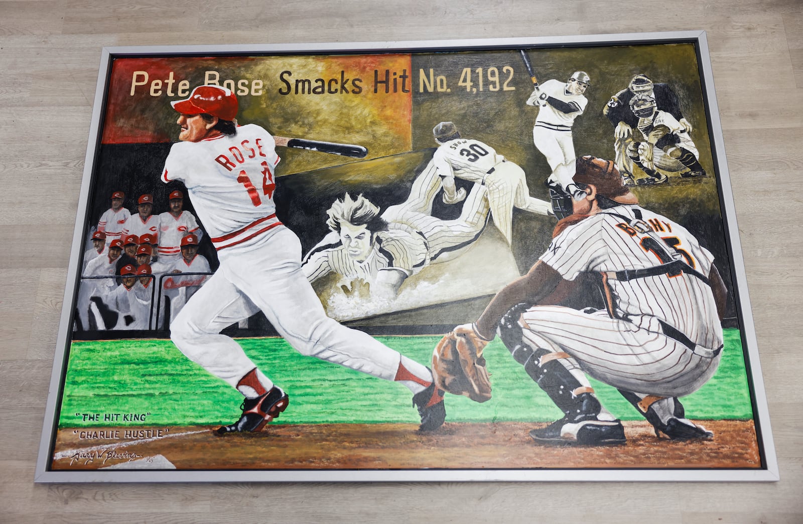 Gary Blevin's painting of MLB legend Pete Rose's 4192nd hit rests on a surface in Blevin's art gallery on Thursday, December 18, 2025, in Springfield. JOSEPH COOKE/STAFF
