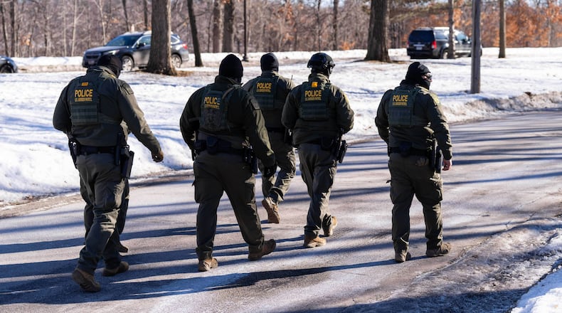 FILE - U.S. Border Patrol officers walk along a street in Minneapolis, Wednesday, Jan. 14, 2026. (AP Photo/Adam Gray,File)