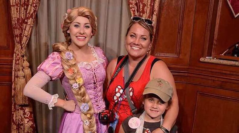 Aviana Finton and her mother, Corri, pose with Rapunzel at Walt Disney World. CONTRIBUTED