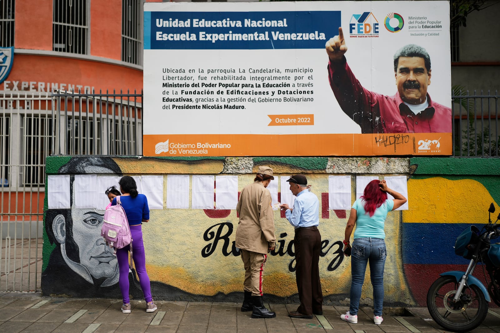Voters look at the rolls at a polling station during legislative and local elections in Caracas, Venezuela, Sunday, May 25, 2025. (AP Photo/Ariana Cubillos)