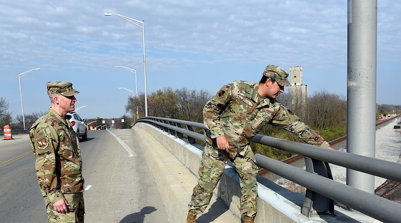 Senior Master Sgt. David Briden (left), Air Force Installation Contracting Center expeditionary operations manager, and Tech. Sgt. Anthony Staton, National Air and Space Intelligence Center, stand on the South Maple Avenue bridge in Fairborn Nov. 20. Two days earlier, the Airmen assigned to Wright-Patterson Air Force Base stopped to aid a teen who was hanging over the side of the bridge and appeared to be in distress. They stayed with the teen until police and medics arrived. A portion of the photo has been altered for security reasons. U.S. AIR FORCE PHOTO/TY GREENLEES