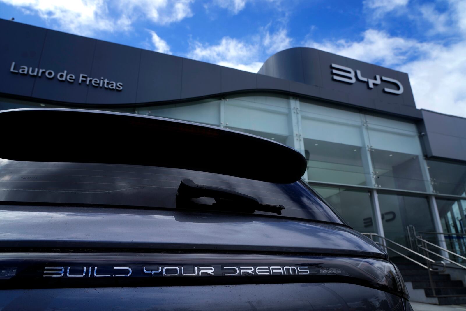 A vehicle says "Build your dreams" as it sits in a BYD car dealership, opened in the same building as a Ford dealership in Camacari, Bahia state, Brazil, Friday, March 7, 2025. (AP Photo/Eraldo Peres)
