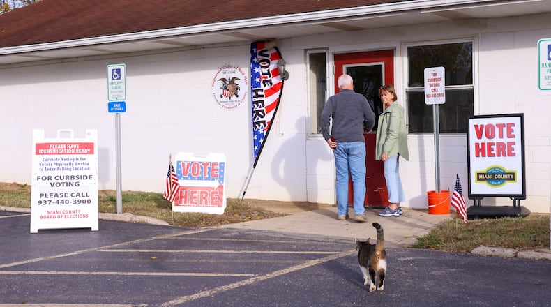 Voters headed to the polls across the area on Tuesday, Nov. 4, including at Redman's Picnic Grounds in Troy. A cat, who poll workers said lives nearby, was greeting voters who were entering the precinct. Poll workers said the cat has done the same on previous election days. BRYANT BILLING/STAFF