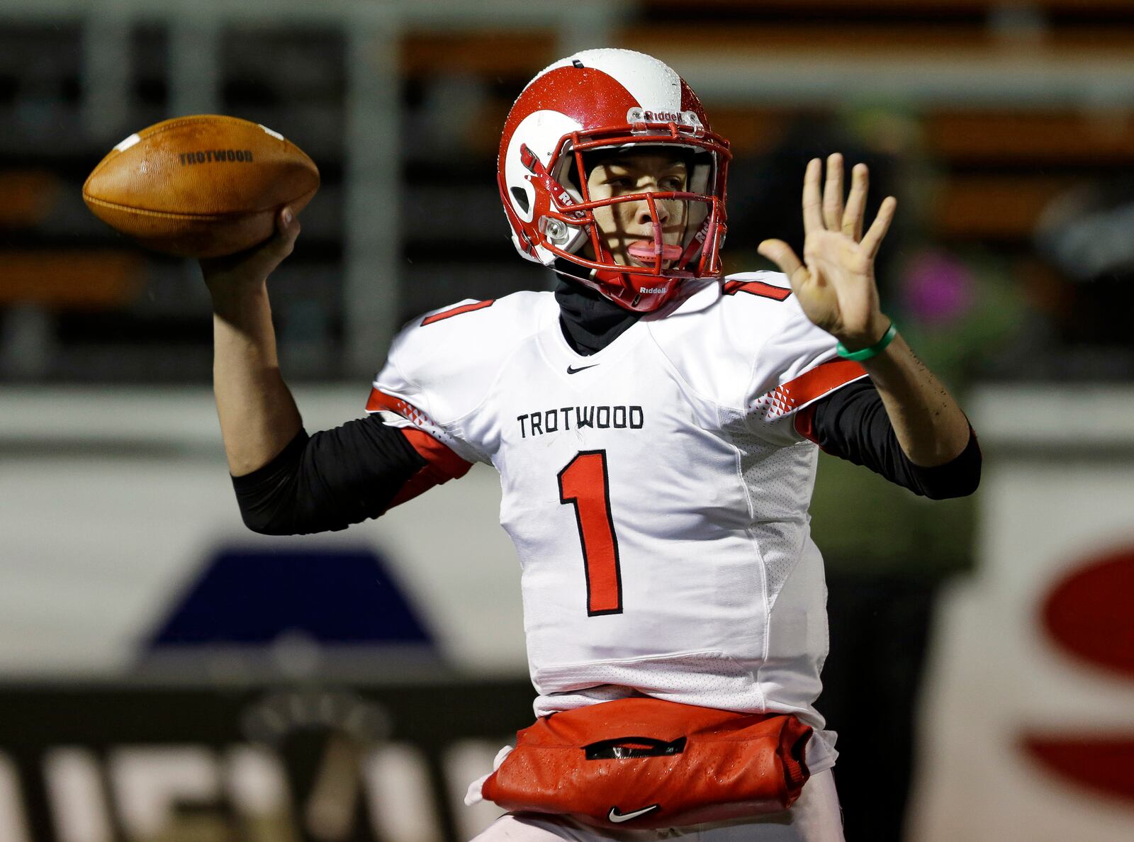 Trotwood-Madison's quarterback Messiah Deweaver passes in the first quarter against Akron St. Vincent-St. Mary in the Ohio Division III high school football championship game Thursday, Dec. 5, 2013, in Massillon, Ohio. (AP Photo/Tony Dejak)