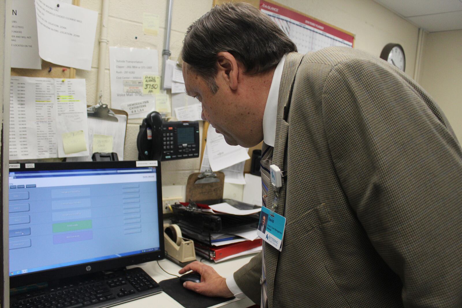 David Starkey, Kettering  Health Network's director of  materials management and biomedical engineering, monitors TUGs via computer. The robots were introduced to Kettering Hospital in January.