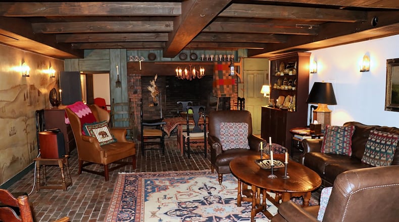 Wood-paneled beamed ceilings add warmth to the lower-level billiard room and a large theater room embellished with an artist’s period-style mural.