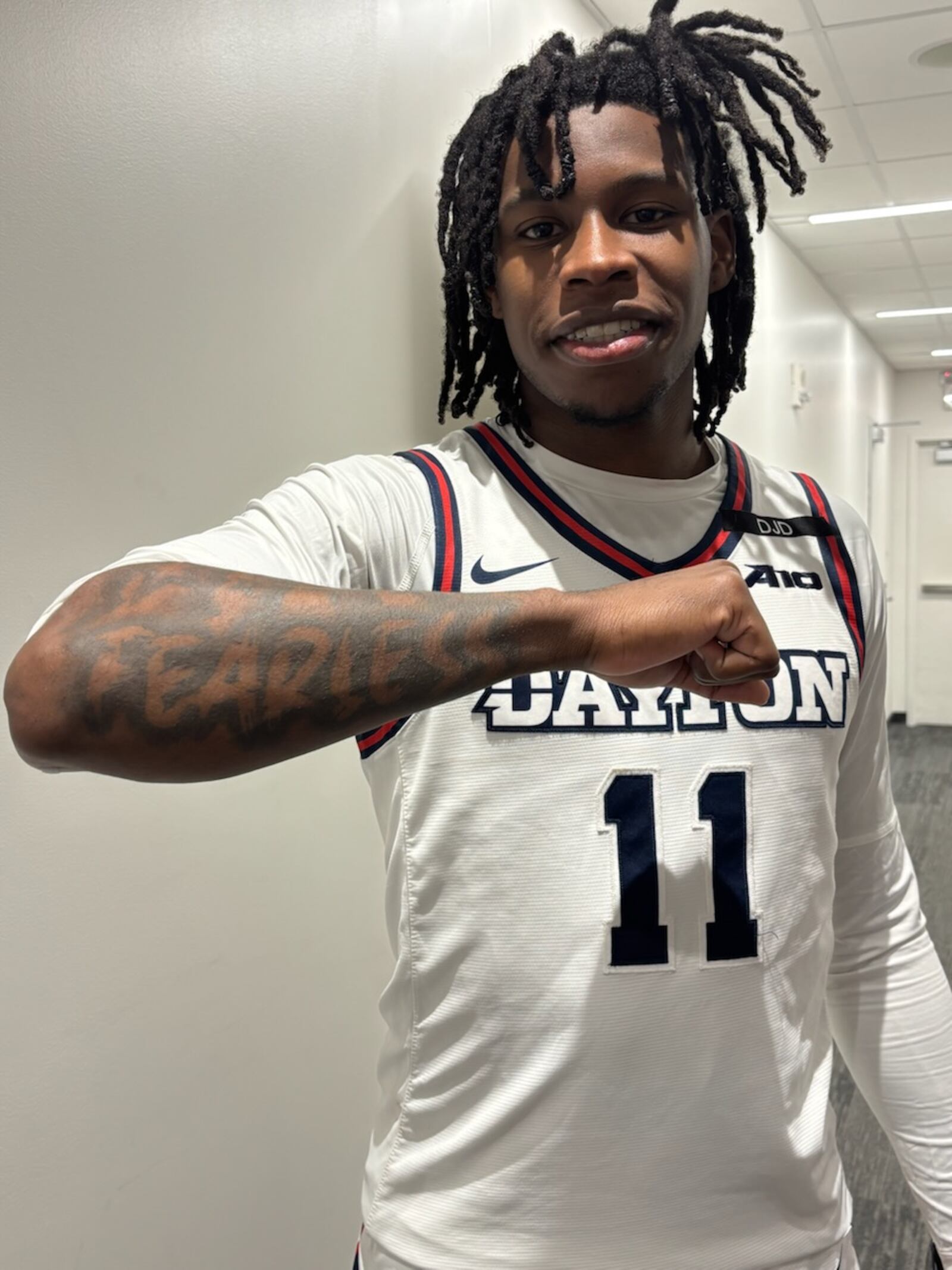 Dayton point guard Malachi Smith shows his 'FEARLESS' tattoo on his right arm after Tuesday night's win over UNLV. Mike Galbraith/CONTRIBUTED