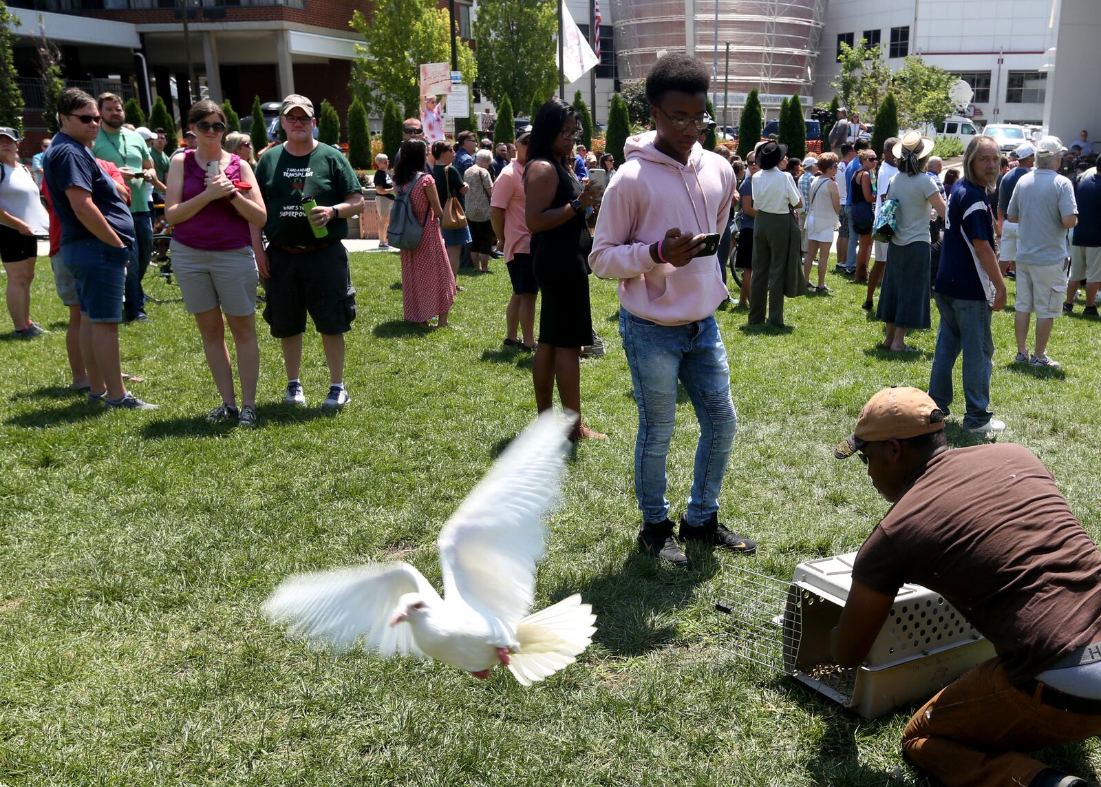 Thomas Jones of Trotwood released nine white pigeons - to symbolize the nine people killed Sunday in Dayton's Oregon District - at a prayer vigil held Sunday afternoon at the Levitt Pavilion. LISA POWELL / STAFF