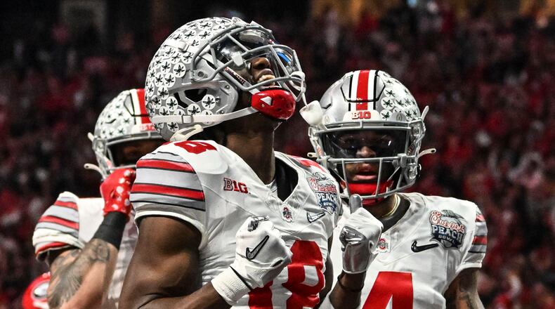 Ohio State wide receiver Marvin Harrison Jr. (18) celebrates his touchdown catch against Georgia during the first half of the Peach Bowl NCAA college football semifinal playoff game, Saturday, Dec. 31, 2022, in Atlanta. (AP Photo/Danny Karnik)