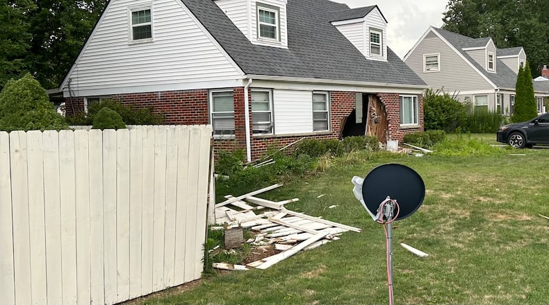 A car crashed into a house on Kenosha Road in Kettering on Monday, July 15, 2024. Police said no one was seriously injured. JEREMY P. KELLEY / STAFF