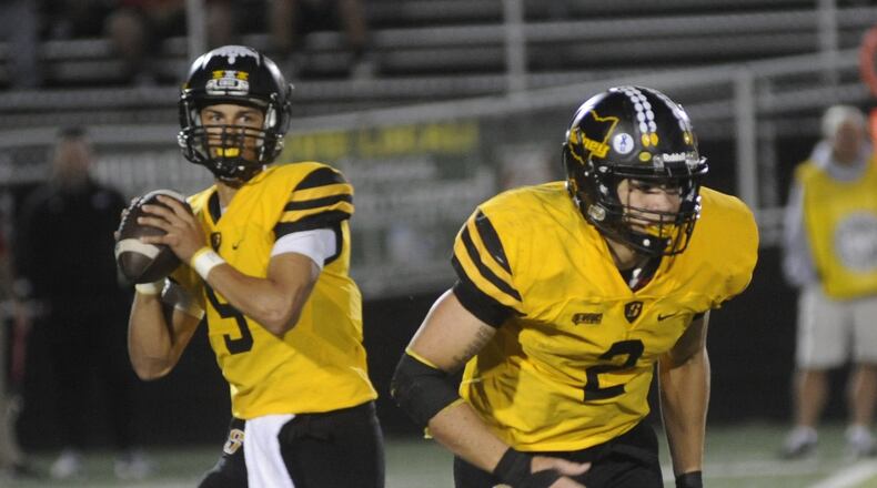Sidney quarterback Andre Gordon and running back Isaiah Bowser execute a play during a 49-42 win over visiting Tippecanoe on Oct. 5. MARC PENDLETON/STAFF