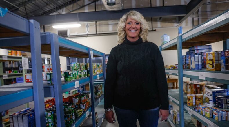 Springboro Community Assistance Center Director, Wendy Grothjan stands in the schools' large food pantry for students and families. JIM NOELKER/STAFF