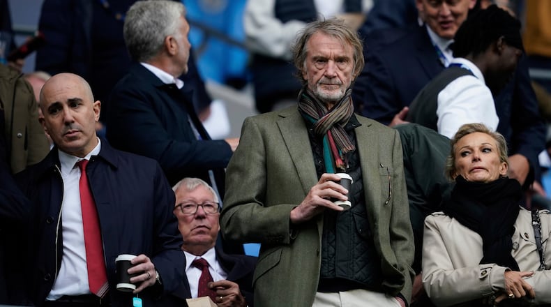 FILE - Manchster United co-owner Jim Ratcliffe stands in front of the former manager Alex Ferguson during the Premier League soccer match between Manchester City and Manchester United in Manchester, England, on Sept. 14, 2025. (AP Photo/Dave Thompson, File)