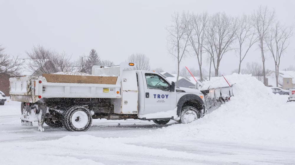 A City of Troy truck clears snow on Meadowpoint Drive on Sunday, Jan. 25. About eight inches had fallen in Troy as of 1 p.m. BRYANT BILLING/STAFF