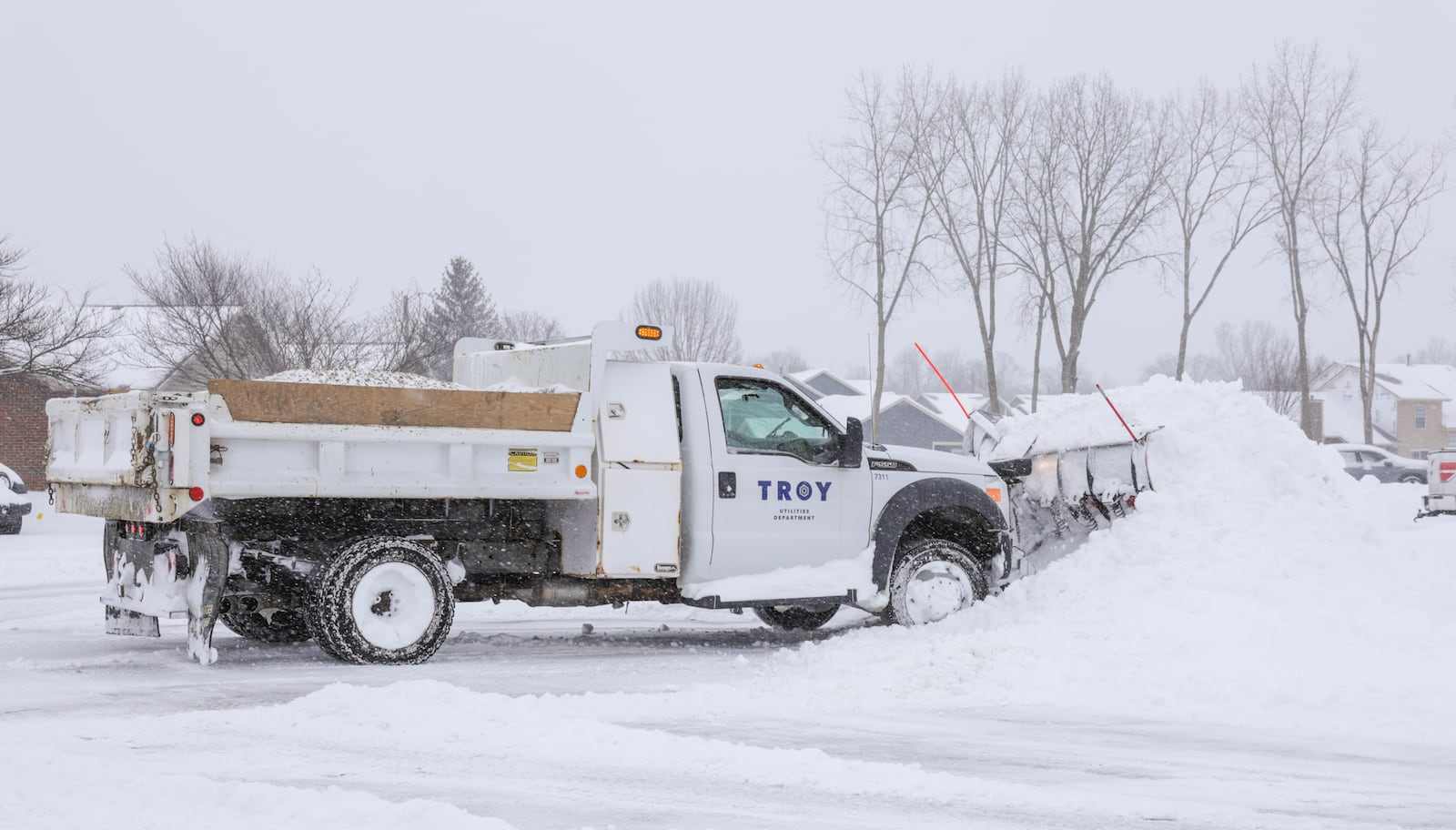 A City of Troy truck clears snow on Meadowpoint Drive on Sunday, Jan. 25. About eight inches had fallen in Troy as of 1 p.m. BRYANT BILLING/STAFF
