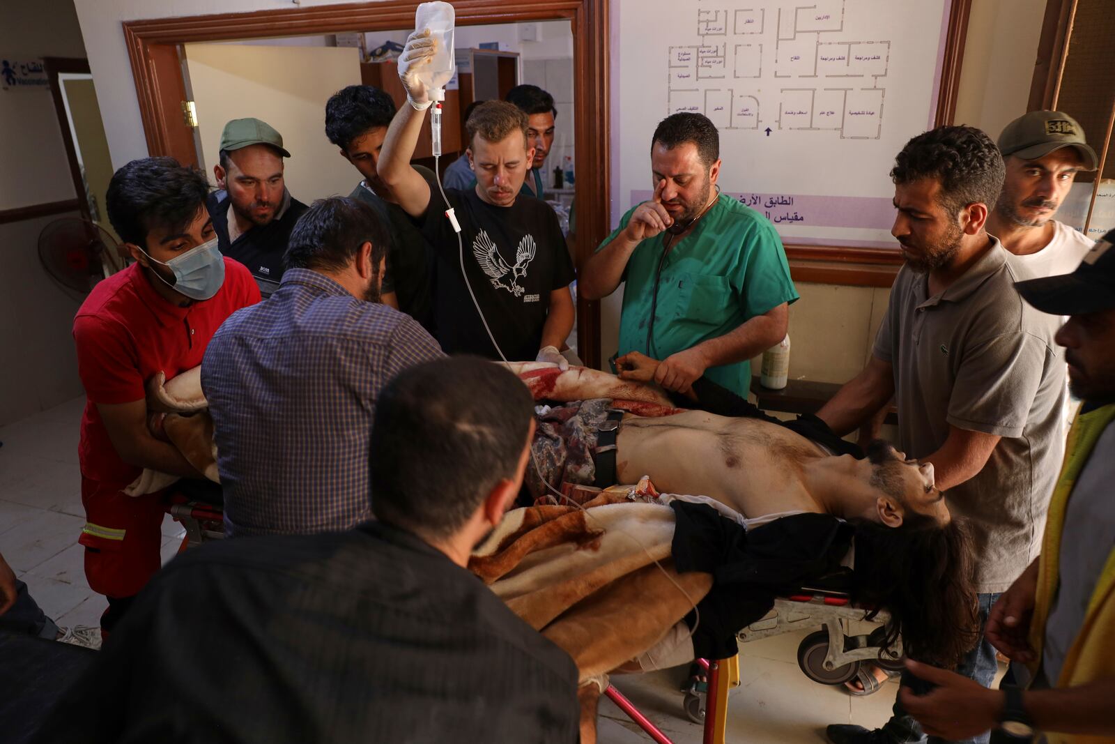 A Syrian government soldier who was injured in Sweida city during clashes between the Syrian government forces and Druze militias, receive treatments at a clinic in Busra al-Harir village, southern Syria, Tuesday, July 15, 2025. (AP Photo/Omar Albam)