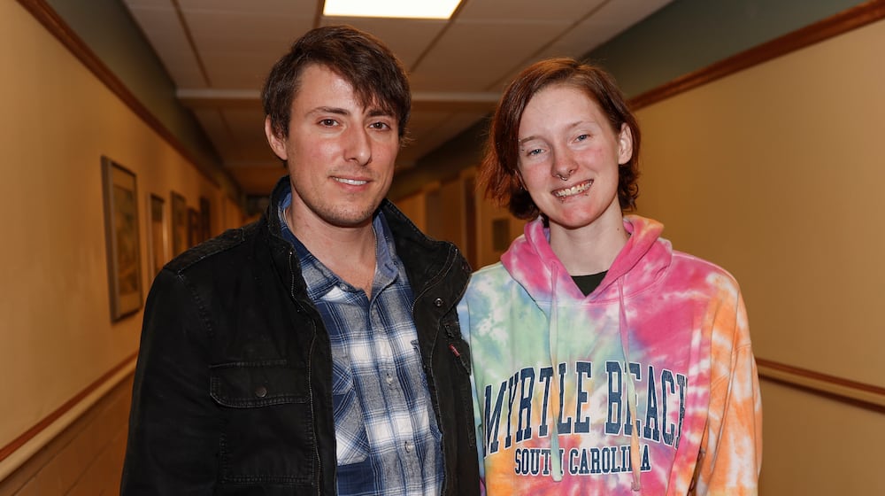 Trevor Adams, left, and his girlfriend Mariah Harville in a hallway at Kettering Health's main campus on Friday, Feb. 27, 2026, in Kettering. Harville supported Adams, 35, as he recently survived cardiogenic shock, a life-threatening condition many people don't live through, where the heart stops pumping enough blood. JOSEPH COOKE/STAFF
