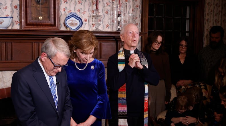 Fr. Tom Hagan, who founded the Becky DeWine School in Haiti, which was named after Gov. DeWine's late daughter, offers a prayer before Ohio Governor Mike DeWine takes the oath of the office during a private ceremony at his residence Sunday, Jan. 8, 2023, in Cedarville, Ohio, as his wife Fran DeWine. (AP Photo/Paul Vernon, Pool)