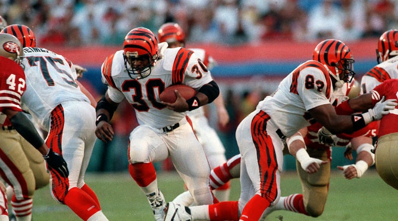 FILE - Cincinnati Bengals' Ickey Woods (30) carries the ball as teammates Bruce Reimers (75) and Rodney Holman (82) block during first-quarter action against the San Francisco 49ers in NFL football's Super Bowl XXIII game in Miami, Fla., Jan. 22, 1989. Players from the 1988 Bengals Super Bowl team are reveling the success in the current team, which is playing in the AFC championship game Sunday, Jan. 30, 2022, in Kansas City. (AP Photo/Rusty Kennedy, File)