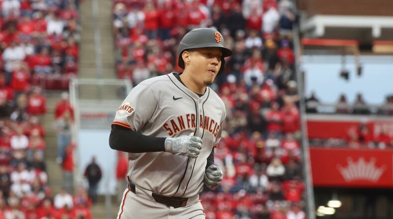 Wilmer Flores, of the Giants, rounds the bases after hitting a tie-breaking, three-run home run against the Reds in the ninth inning on Thursday, March 27, 2025, on Opening Day at Great American Ball Park in Cincinnati. David Jablonski/Staff
