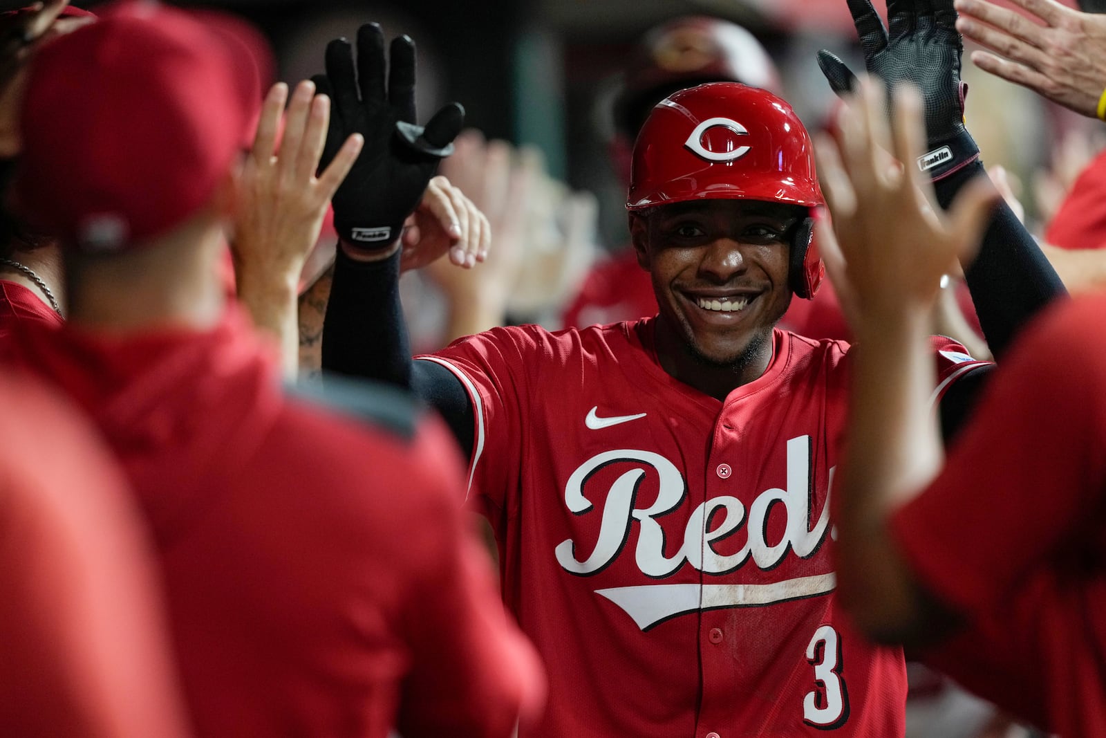 Cincinnati Reds' Ke'Bryan Hayes celebrates in the dugout after hitting a three-run homer during the eighth inning of a baseball game against the Atlanta Braves, Thursday, July 31, 2025, in Cincinnati. (AP Photo/Carolyn Kaster)