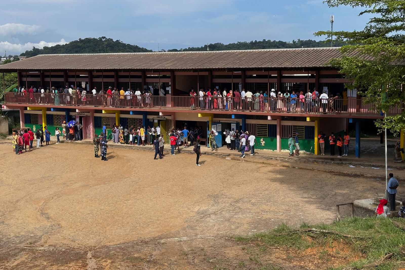 Voters queue to cast their votes for the presidential elections outside a polling station, in Liberville, Gabon, Saturday, April 12, 2025. (AP Photo/Betines Makosso)
