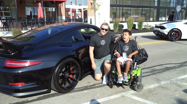 Driver Josh Haws and Jesse Burns prepare to board the Porsche GT3 and take it for a spin at the JoyRide event Aug. 26 at Austin Landing. CONTRIBUTED