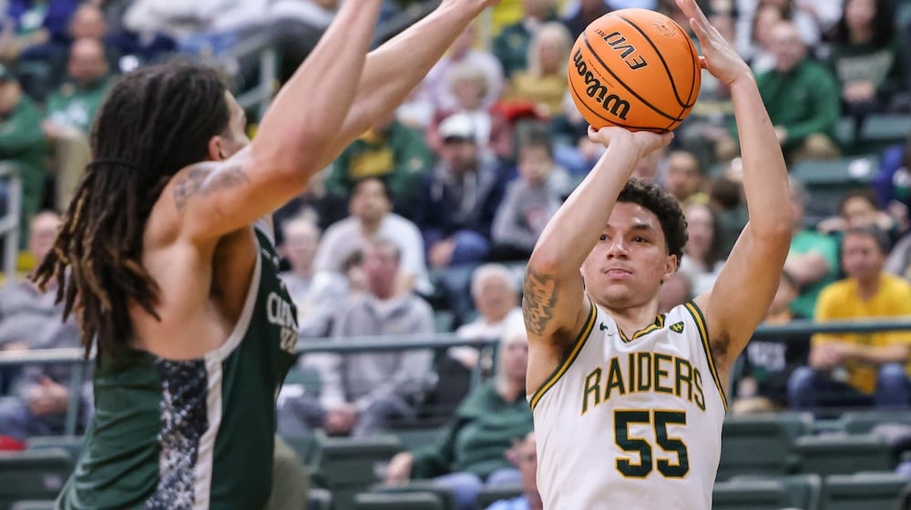 Wright State freshman guard Michael Cooper shoots with pressure from Cleveland State's Priest Ryan during a Horizon League Championship first-round game on Wednesday, March 4 at Ervin J. Nutter Center in Fairborn. BRYANT BILLING / STAFF