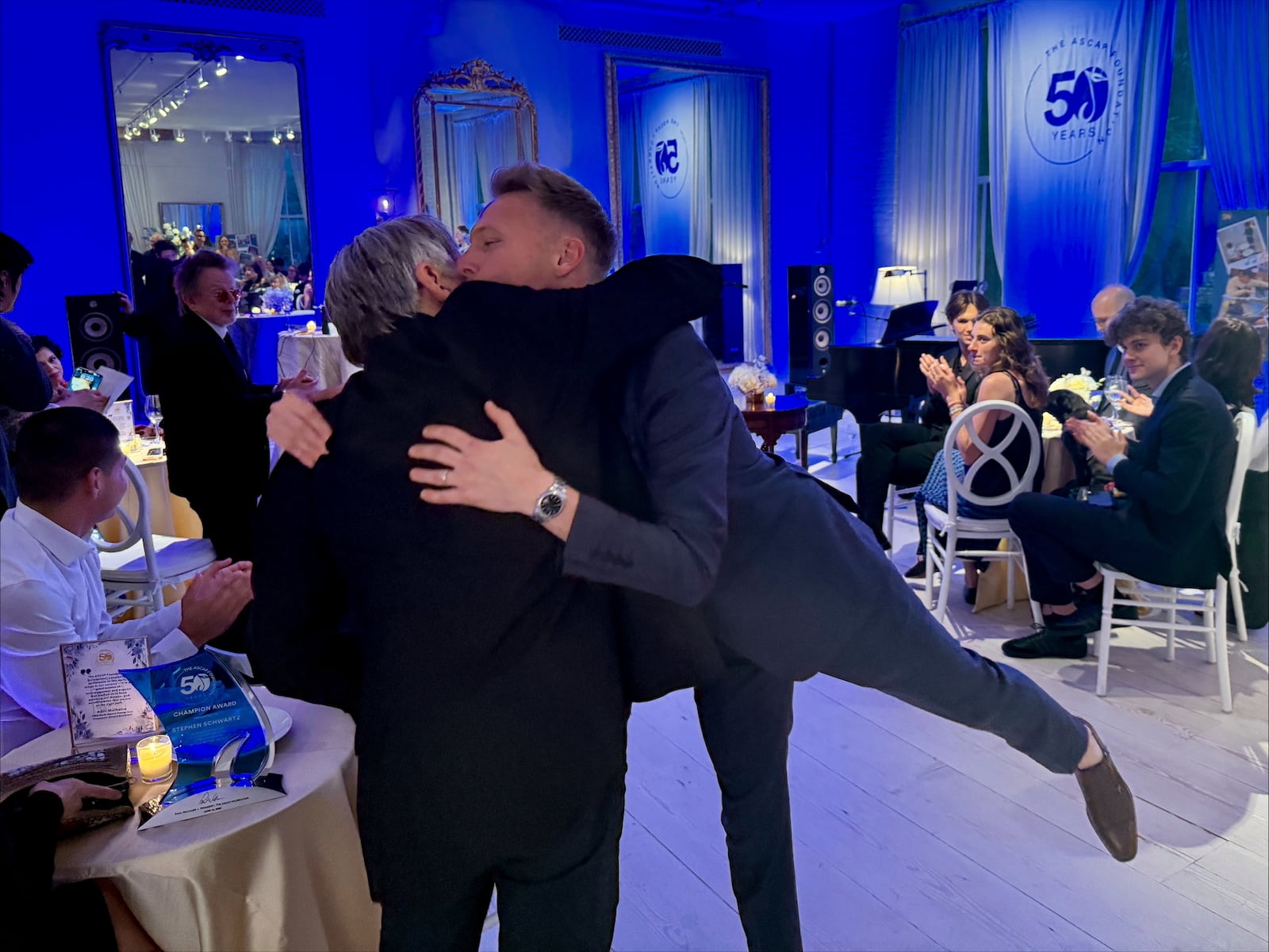 Justin Paul, right, hugs Stephen Schwartz after performing the song Morning Glow from the musical Pippin at the ASCAP Foundation's 50th anniversary celebration in Manhattan, New York on Tuesday, June 10, 2025. (AP Photo/James Pollard)