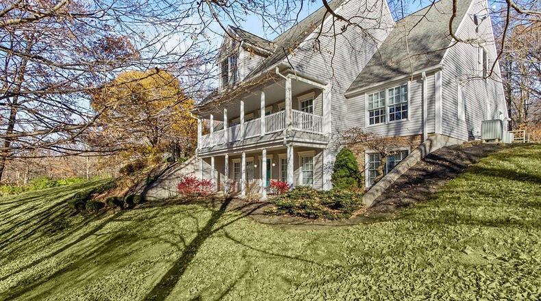 The front of the home features two covered porches: one on the main level and another off the walk-out basement. PHOTOS PROVIDED BY HR REAL ESTATE PHOTOGRAPHY & MEDIA, HEATHER HUNT