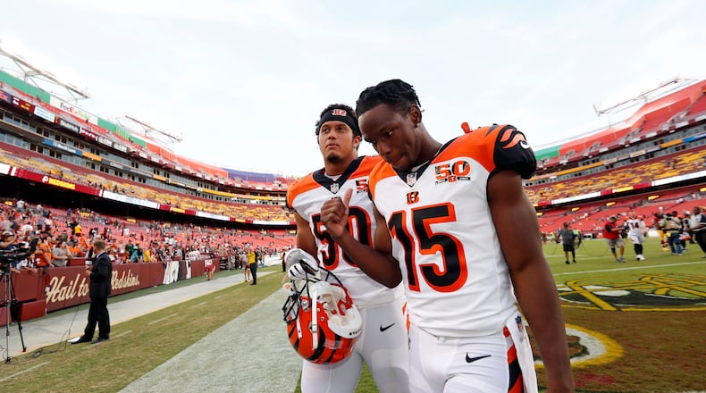 Cincinnati Bengals linebacker Jordan Evans (50) and wide receiver John Ross walk off the field after a preseason NFL football game against the Washington Redskins, Sunday, Aug. 27, 2017, in Landover, Md. (AP Photo/Alex Brandon)