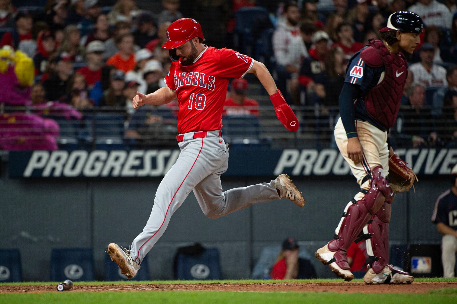 Los Angeles Angels' Nolan Schanuel scores on an RBI single by Jorge Soler as Cleveland Guardians' Bo Naylor stands by during the seventh inning of a baseball game, Friday, May 30, 2025, in Cleveland. (AP Photo/Phil Long)