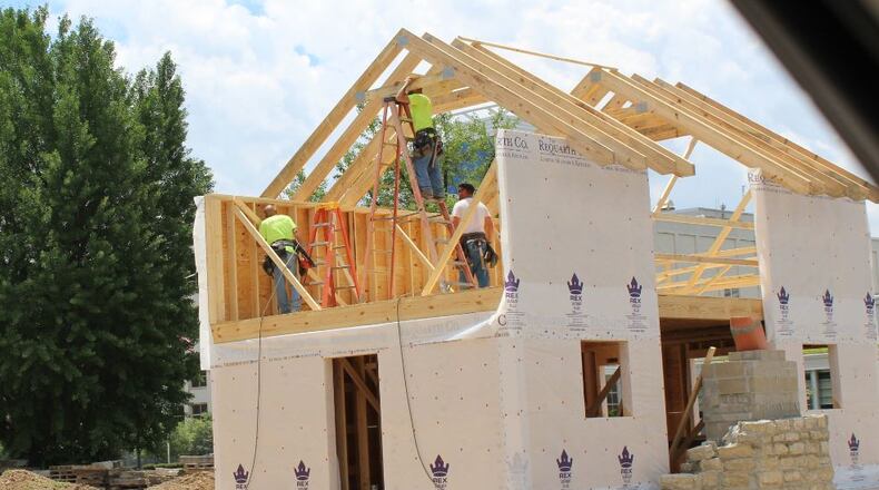 Crews work to build a home near the University of Dayton on South Main Street. CORNELIUS FROLIK / STAFF