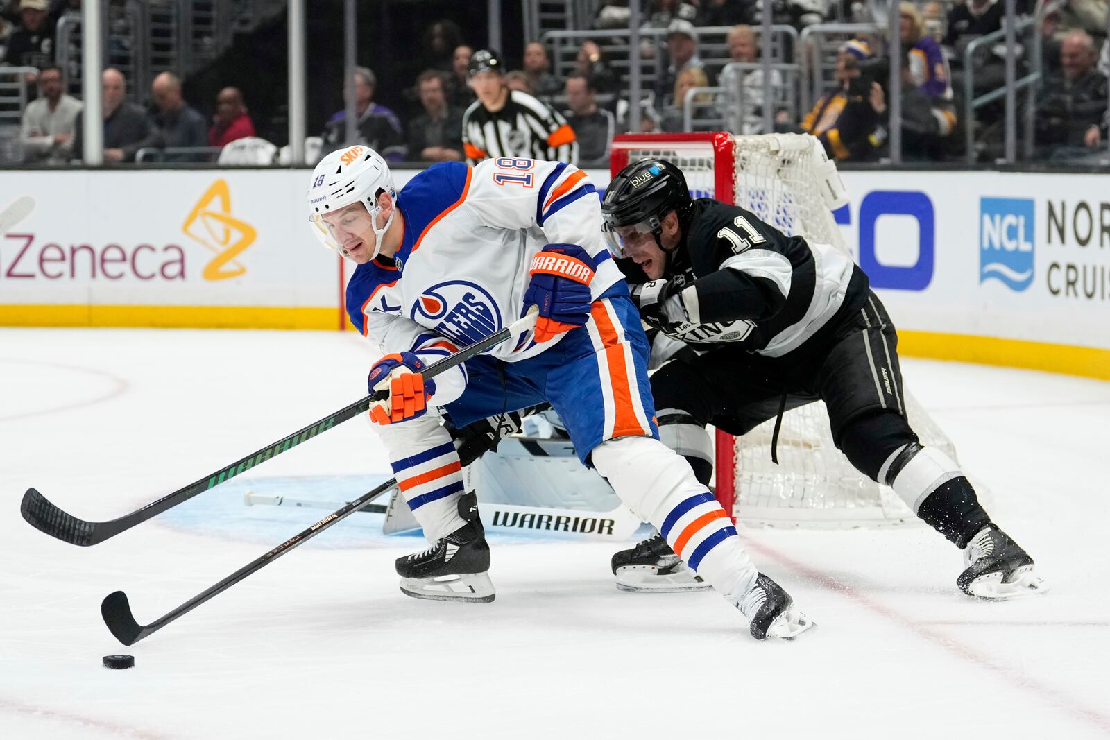 Edmonton Oilers left wing Zach Hyman, left, moves the puck as Los Angeles Kings center Anze Kopitar puts pressure on him during the first period in Game 2 of an NHL hockey first-round playoff series Wednesday, April 23, 2025, in Los Angeles. (AP Photo/Mark J. Terrill)