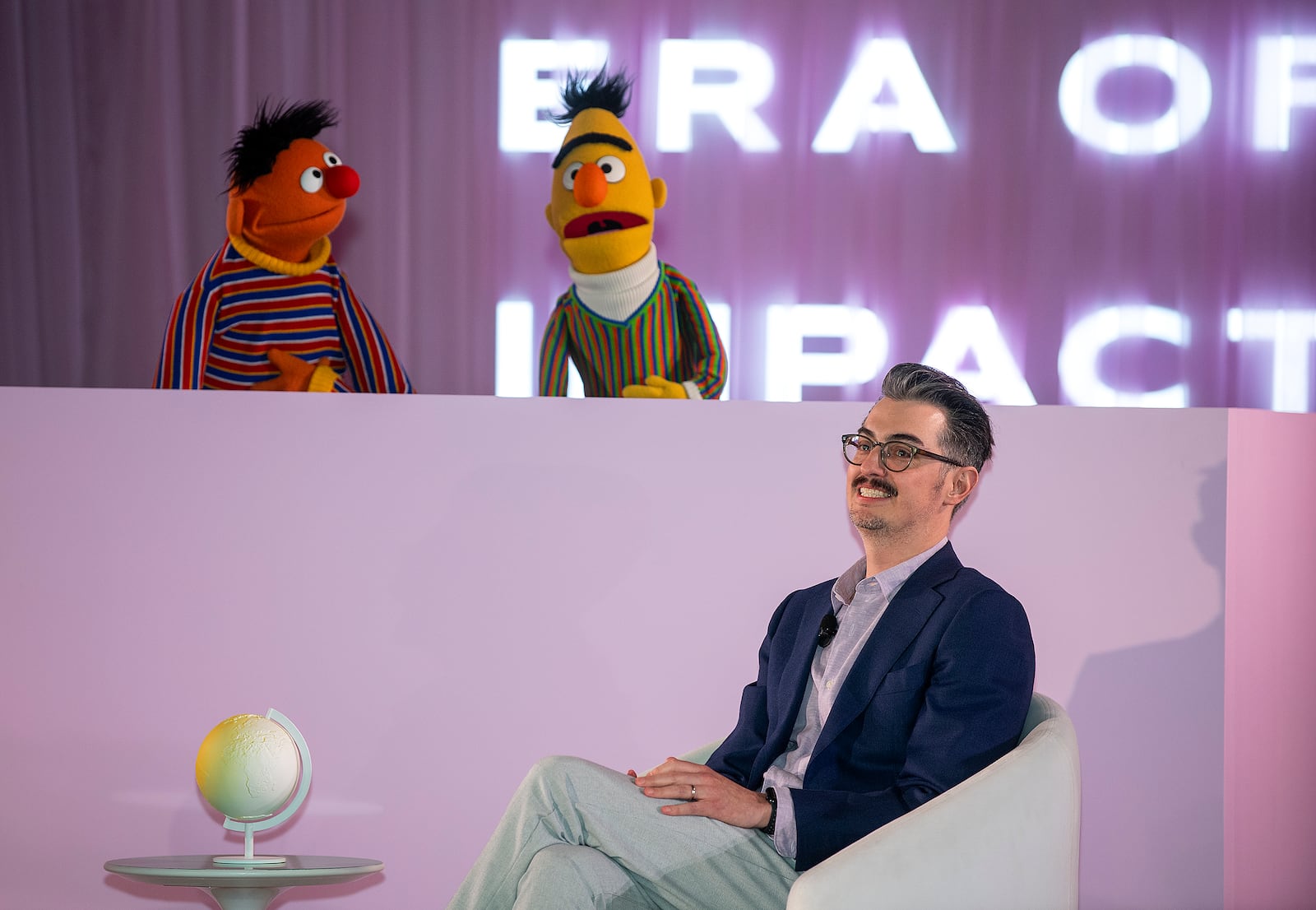 Sesame Street's Bert and Ernie speak with Sal Perez, executive producer and VP of Sesame Street at Sesame Workshop, after Sesame Workshop won the Elevate Prize Foundation's Catalyst Award, Wednesday, May 14, 2025, in Miami Beach, Fla. (AP Photo/Michael Laughlin)